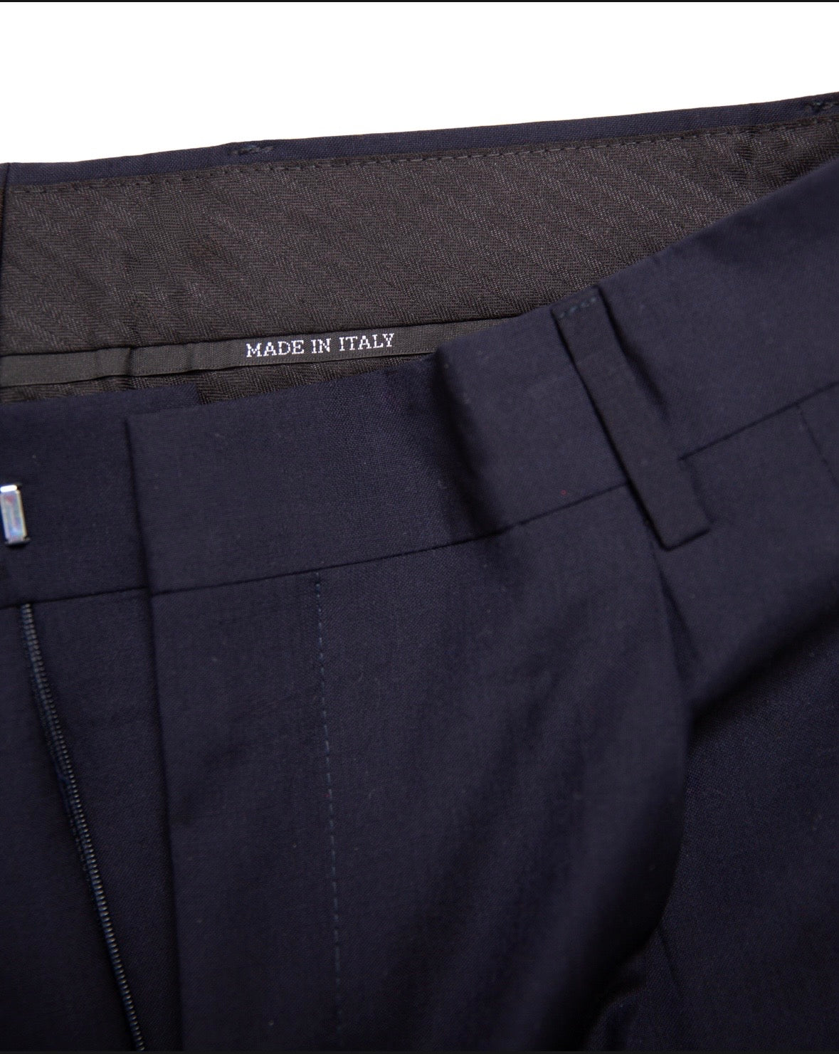 Navy blue pants with 'Made in Italy' label on a white background