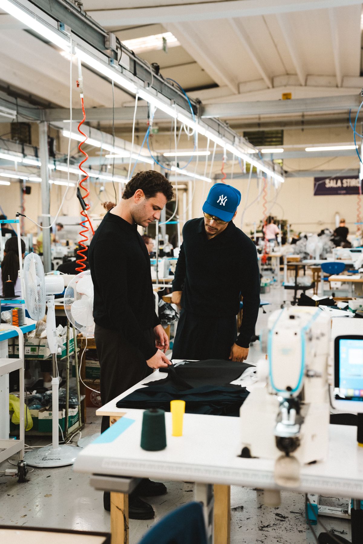 Founders The founders at a cutting table in the factory in Italy
