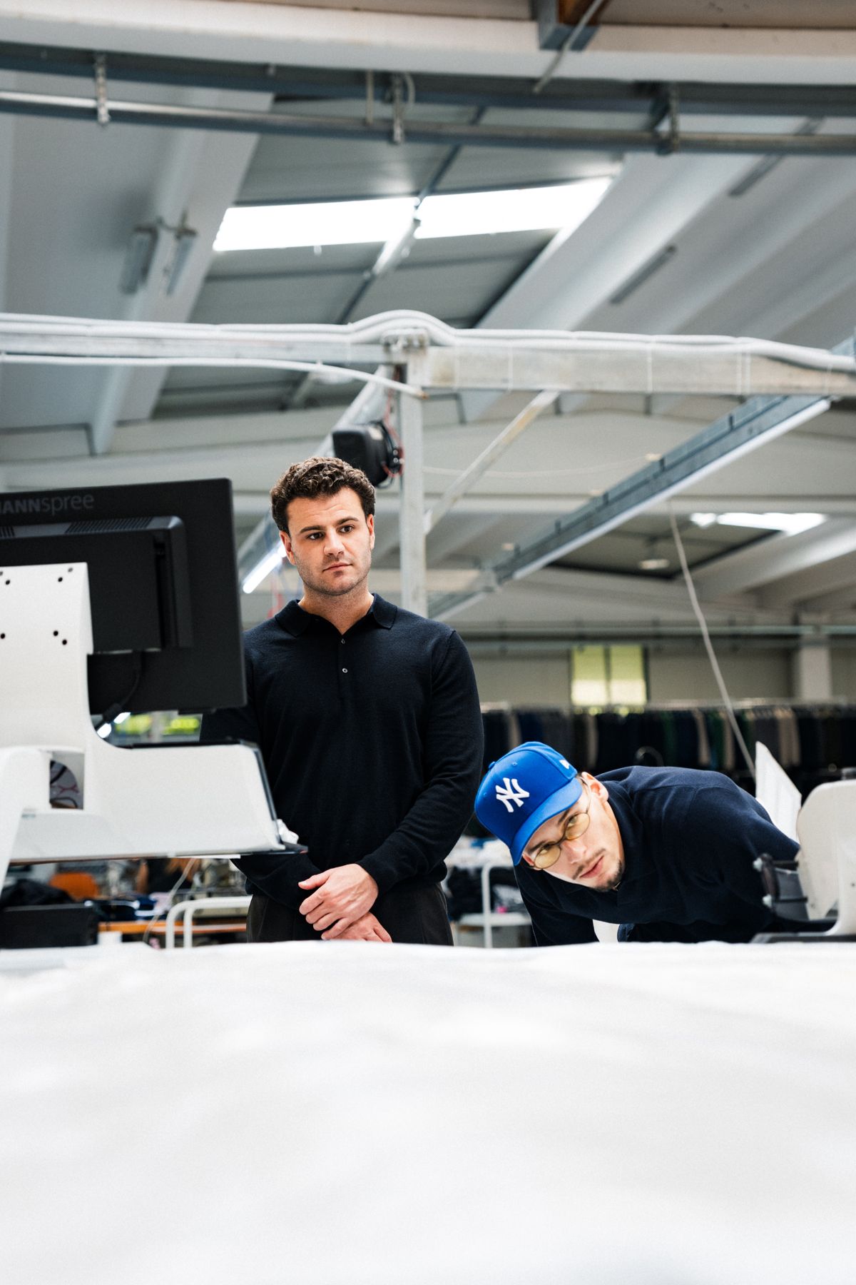 The founders looking over a garment at the factory