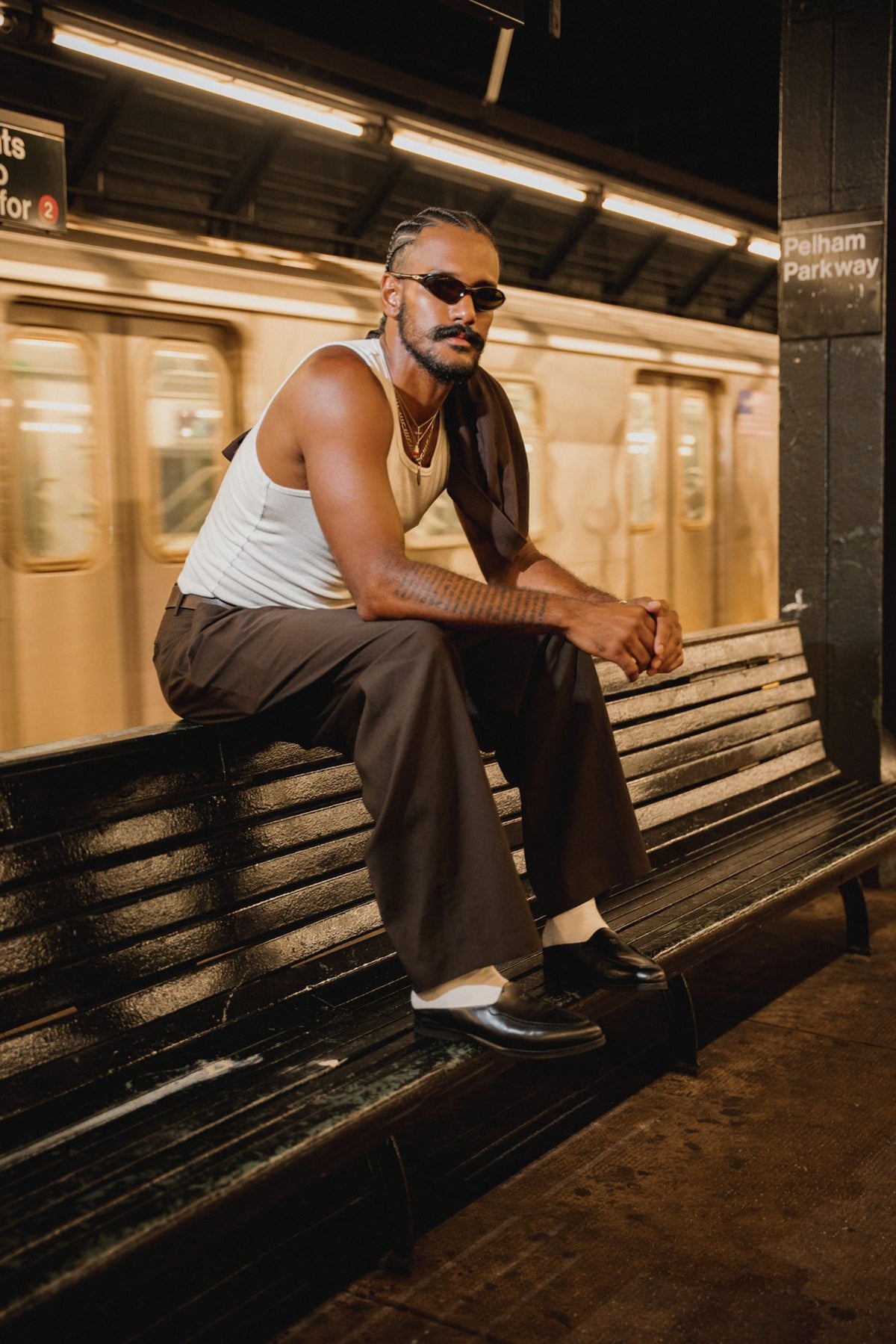 Liam in Once in a Blue pleated trousers on the subway in New York